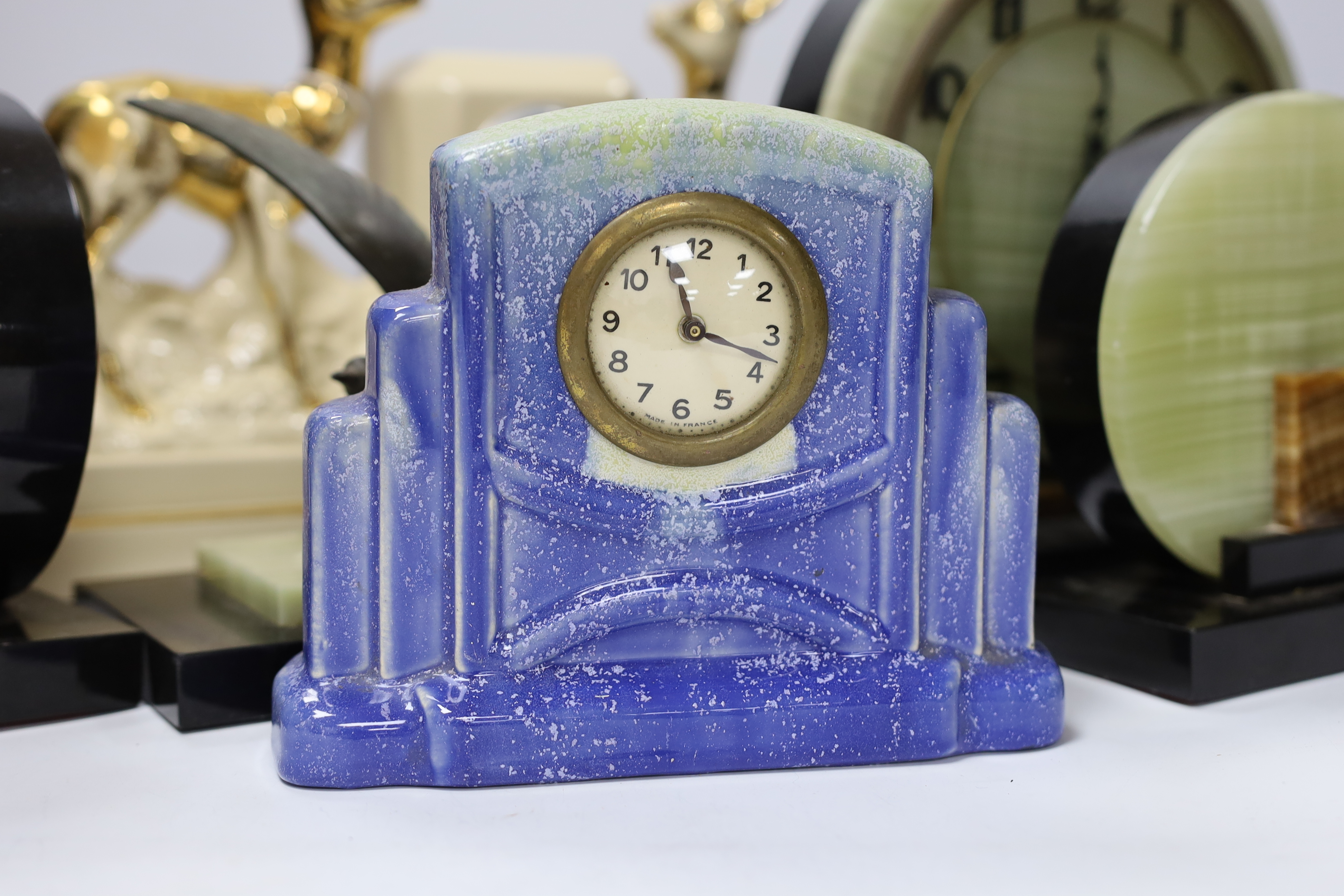 A French Art Deco green onyx clock garniture with Blue bird spelter mount, clock 46cm wide